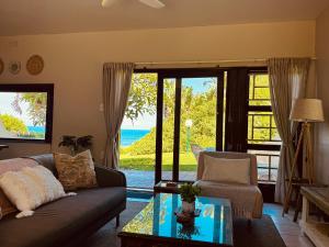 a living room with a couch and a glass table at Rockshore at Seaverge in Port Edward