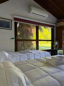 a group of white beds in a room with a window at LPR EZE Airport in La Unión +21 photos