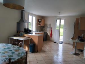 a kitchen with a table and a counter top at La Bourgandie in Englesqueville-la-Percée