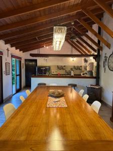 a dining room with a large wooden table and chairs at LPR EZE Airport in La Unión