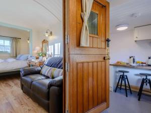 a door leading to a living room with a couch at 1 Bed in Conwy oc-79464 in Conwy