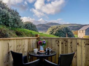 a patio with a table and chairs on a fence at 1 Bed in Conwy oc-79464 in Conwy