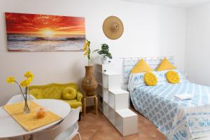 a bedroom with a bed and a table and a table and chairs at Casa Rica in Alghero