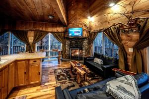 a living room with a couch and a fireplace at Tree House in Helen