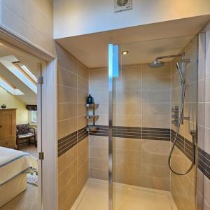 a bathroom with a shower with a glass door at Talbot Lodge BnB - Two ensuite bedrooms, near Bicester in Middleton Stoney