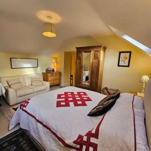 a bedroom with a large bed with an ak sign on it at Talbot Lodge BnB - Two ensuite bedrooms, near Bicester in Middleton Stoney