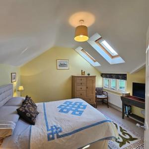 a bedroom with a large bed and a piano at Talbot Lodge BnB - Two ensuite bedrooms, near Bicester in Middleton Stoney