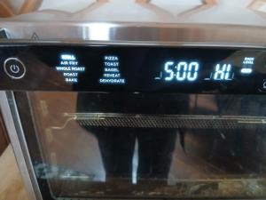 a microwave with a clock on top of it at The Snowdrop in Galway +2 photos