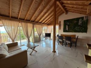 a living room with a couch and a table at Eleonor Guest House in Byala