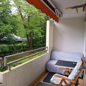 a balcony with a table and a chair at Brilliant Home Messe in Nuremberg
