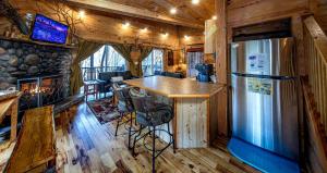 a kitchen with a refrigerator and a bar in a cabin at Tree House in Helen