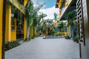 a courtyard of a building with palm trees at Tam Coc Mango Homestay - Free Swimming Pool in Ninh Binh