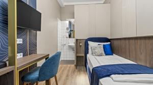 a small room with a bed and a desk and chair at Odeon near Nestroyplatz with Self Check-in & Private External Bathroom in Vienna +16 photos