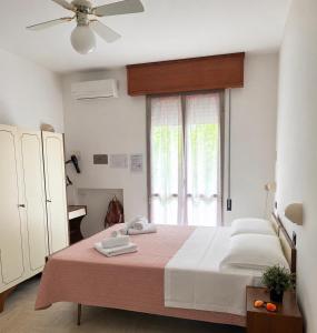 a bedroom with a large bed and a window at Hotel Podgora Nuova Gestione in Rimini