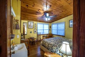 a bedroom with a bed and a wooden ceiling at The Lodge in Helen