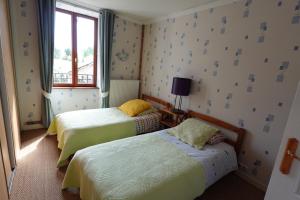 a bedroom with two beds and a window at Chez Kahina ancien hôtel Robert in Giat
