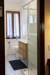 a bathroom with a toilet and a sink and a shower at Casa Rica in Alghero