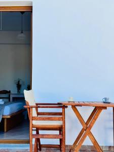 a wooden table and a chair and a bed at Limnes Seaside Combo in Ligaridia