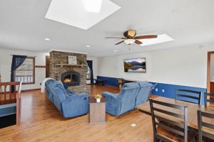 a living room with blue chairs and a fireplace at Vista Ridge at Alpine 4BDR in Jasper