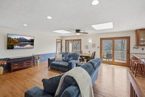 a living room with two blue chairs and a table at Vista Ridge at Alpine 4BDR in Jasper