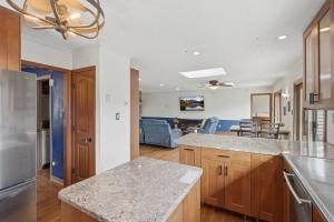 a kitchen with wooden cabinets and a counter top at Vista Ridge at Alpine 4BDR in Jasper +18 photos