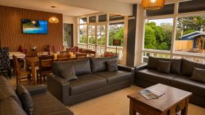 a living room with a couch and a table at Mojomar Pinamar Hotel in Pinamar