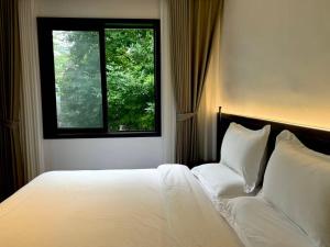 a bedroom with a white bed and a window at 璞宿清居民宿 in Xi'an +58 photos