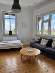 a living room with a couch and a table at Luxe Apartment am Rhein in Worms