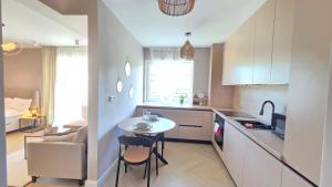 a kitchen with a table and a small table and chairs at Your home away from home 3 in Floreşti