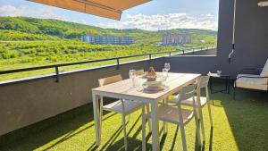 a white table and chairs on a balcony with a view at Your home away from home 3 in Floreşti