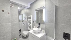 a bathroom with a toilet and a sink and a shower at Your home away from home 3 in Floreşti +25 photos