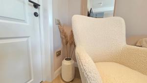 a room with a chair and a vase with a plant at Your home away from home 3 in Floreşti