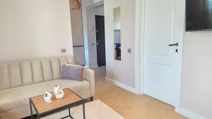 a living room with a couch and a table at Your home away from home 3 in Floreşti