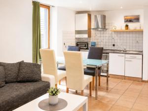 a living room with a couch and a table with chairs at Ferienwohnungen auf Reiterhof in Kevelaer in Kevelaer