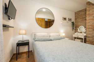 a bedroom with a bed and a mirror on the wall at La Pedica B&B in Grottaferrata