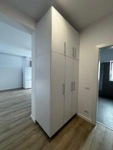 a large white closet in a room with wood floors at VISAJ Escape in Timişoara