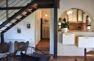 a kitchen and dining room with a staircase in a house at Casa Jasmine by Lisetta in Migiana