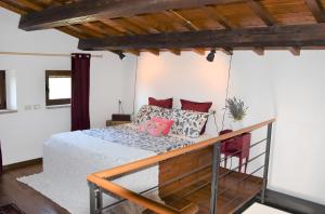 a bedroom with a bed with red pillows at Casa Jasmine by Lisetta in Migiana +28 photos
