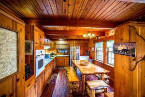 a kitchen with wooden walls and a table in a cabin at The Lodge in Helen