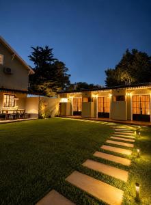 a backyard at night with lights on the grass at Armonium Airport in Ezeiza