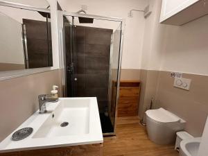 a bathroom with a sink and a shower and a toilet at Bilocale Is Molas Design, Giardino e Relax in Is Molas 