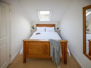 a small bedroom with a bed and a window at Hayloft - Ukc4678 in Clynnog-fawr