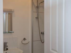 a bathroom with a shower and a sink at Hayloft - Ukc4678 in Clynnog-fawr +3 photos