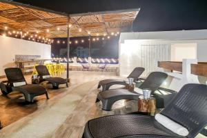 a waiting room with chairs and a barber shop at Valentina Suites by Las Flores Vacation Rentals in Playa del Carmen +37 photos