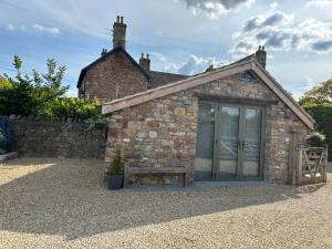 a small brick building with a bench in front of it at The Barn in Bristol +3 photos