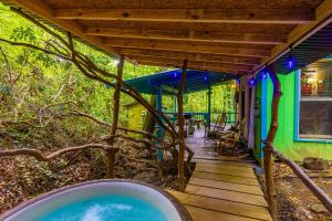a house with a hot tub in the woods at Cozy Cabin in Helen