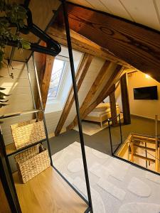 an attic room with a ladder and a window at Zentrales Design Loft über den Dächern St Gallens in St. Gallen