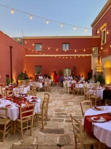a restaurant with tables and chairs with people sitting at them at Antica Masseria le Monache in Grottaglie