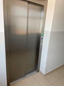 a stainless steel elevator in a building at Apartament pod dębami in Trzcianka