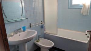 a bathroom with a sink and a toilet at Marychris in Saint-Loubès +5 photos